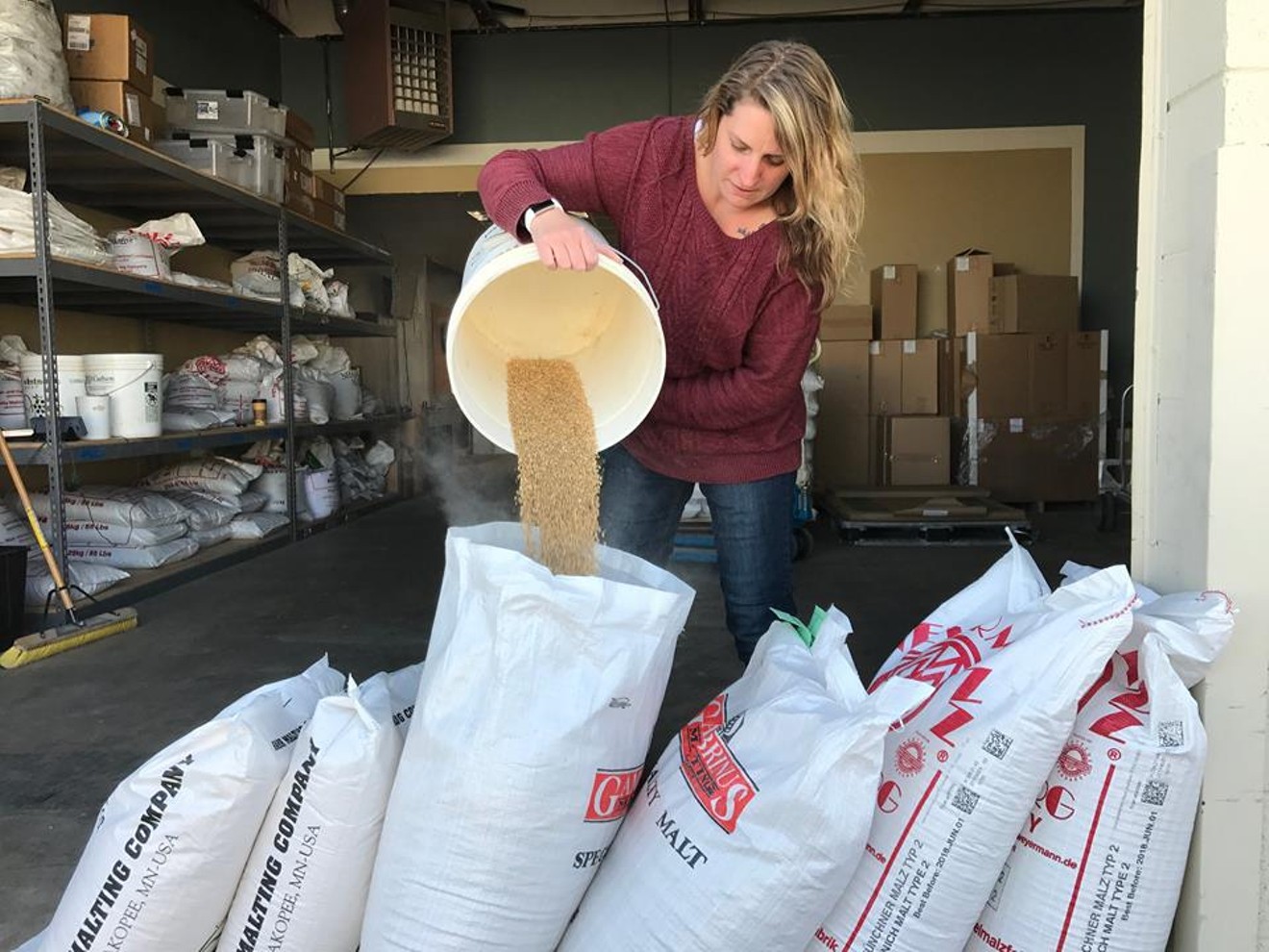 Lone Tree taproom manager Emily preps the malt for brew day.