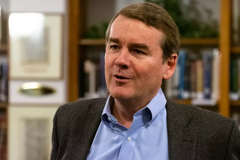 Image: Senator Michael Bennet at a town-hall meeting on November 29.
