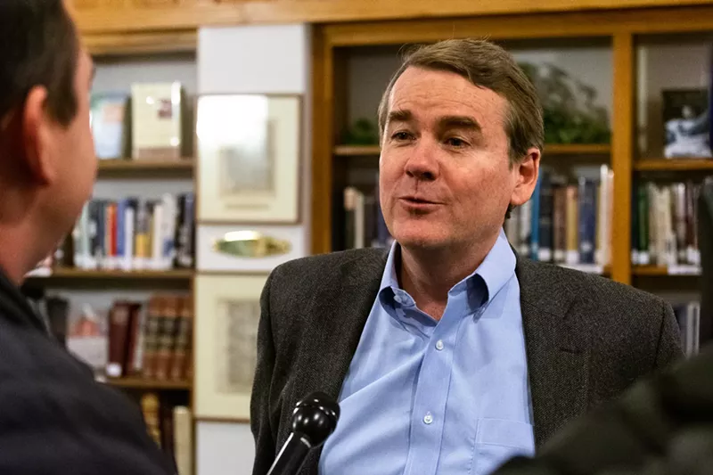 Image: Senator Michael Bennet at a town-hall meeting on November 29.