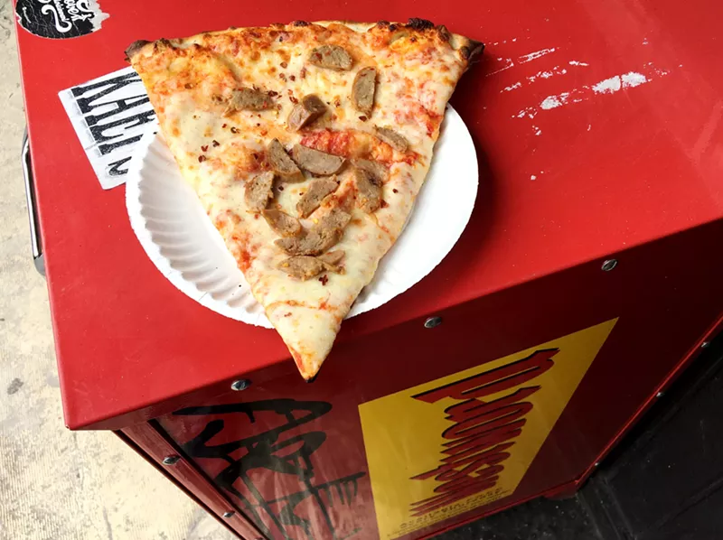 Image: slice of pizza on newspaper box
