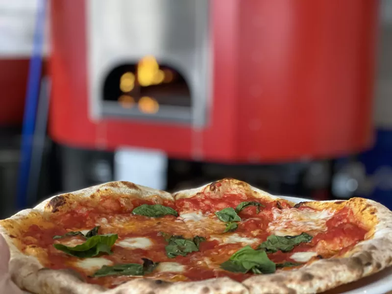 Image: Pair your pizza at Benzina with a game of bocce ball.
