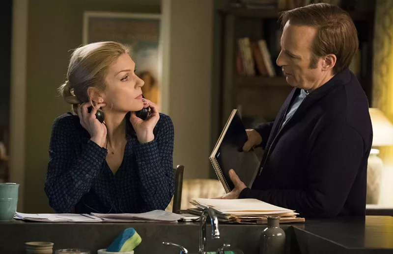Image: Bob Odenkirk (right) plays Saul Goodman, née Jimmy McGill, a shyster/lawyer with a fake name who gets down to business with his lawyer girlfriend, Kim Wexler (Rhea Seehorn), in the AMC drama Better Call Saul.