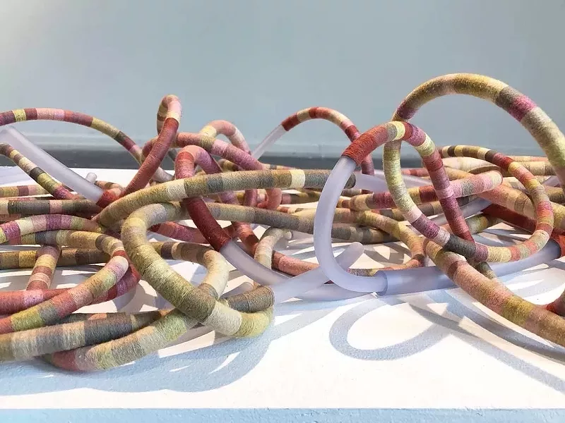 Image: Tali Weinberg, "Bound," 2024, temperature data for 300 places around the globe, petrochemical-derived medical tubing, plant fibers, plant and insect dyes.