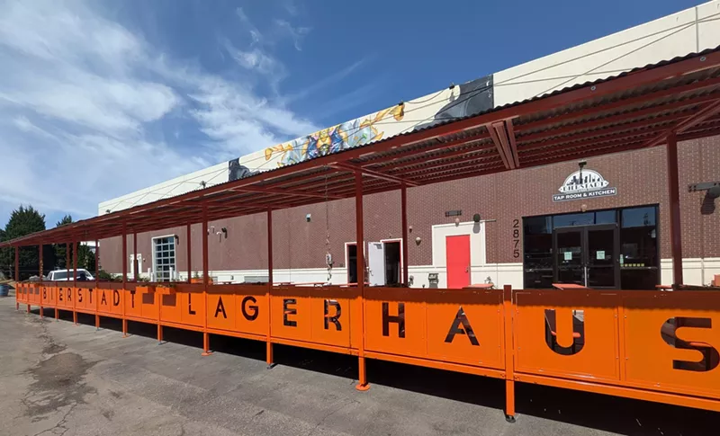 Image: Covered patio with orange metal work.