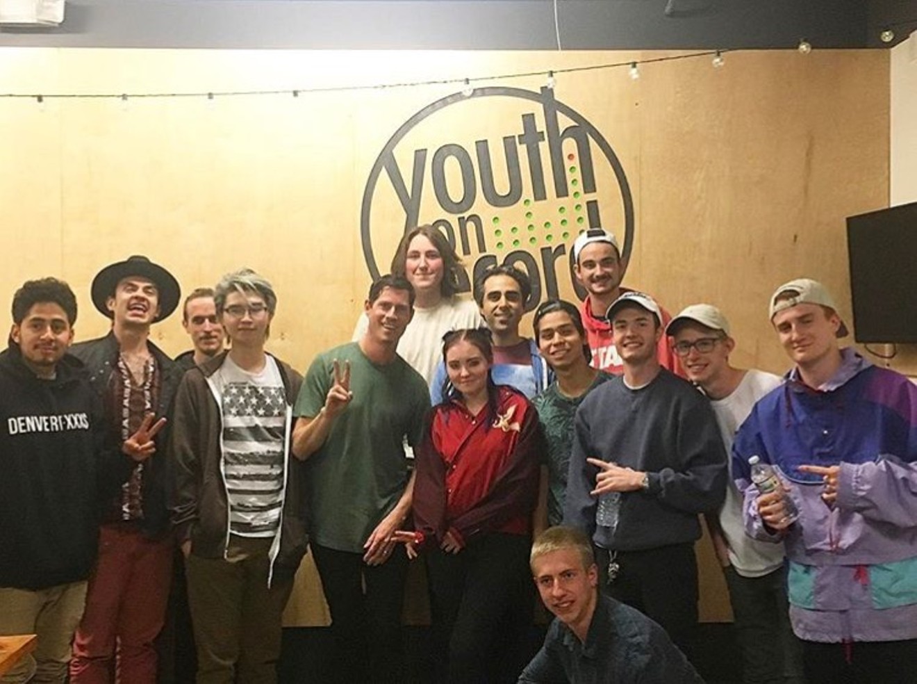 Dominic Lalli (center, in green) enjoys working with the teens at Youth on Record, noting their passion and curiosity about music.