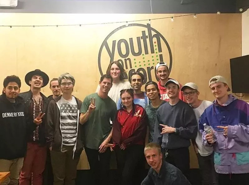 Image: Dominic Lalli (center, in green) enjoys working with the teens at Youth on Record, noting their passion and curiosity about music.