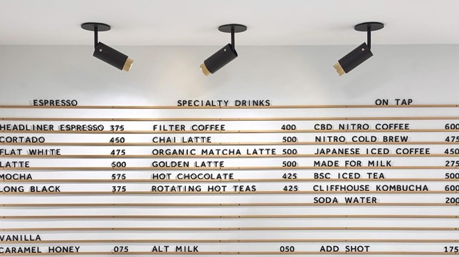a white menu board with black letters