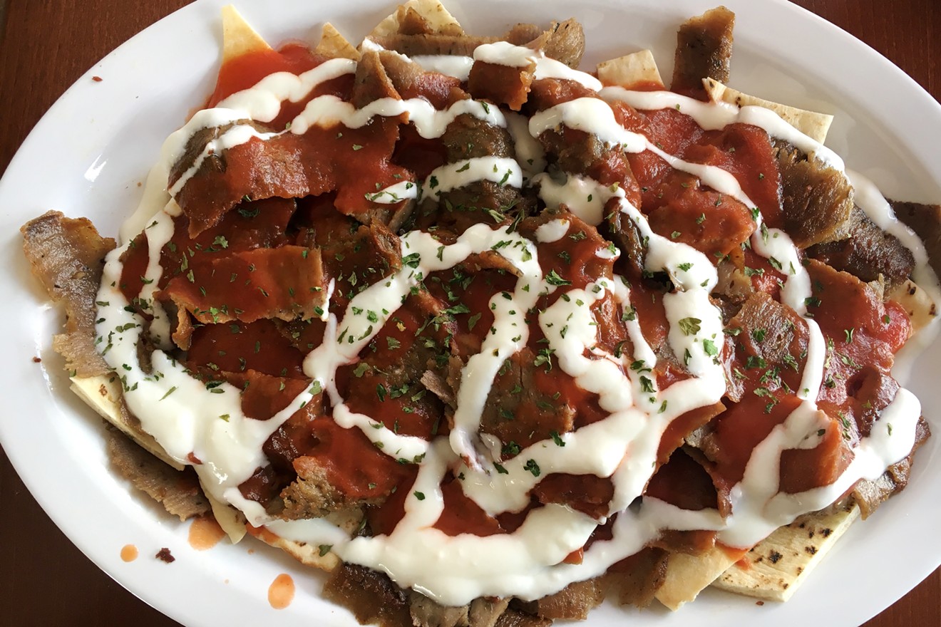 Iskender kebab is a traditional Turkish dish served with tomato sauce and yogurt.