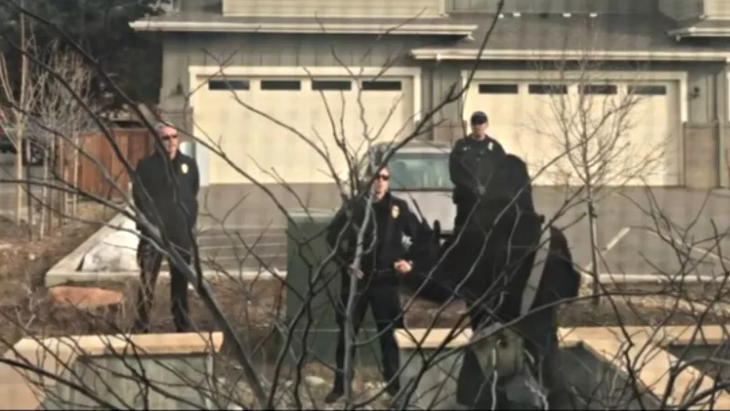 Image: A screen capture of a video showing Boulder resident Zayd Atkinson being rousted by police for picking up trash at his own home on March 1.