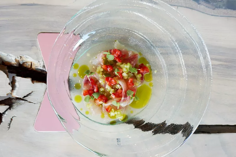 Image: Striped bass with berries, celery, whey and basil oil.