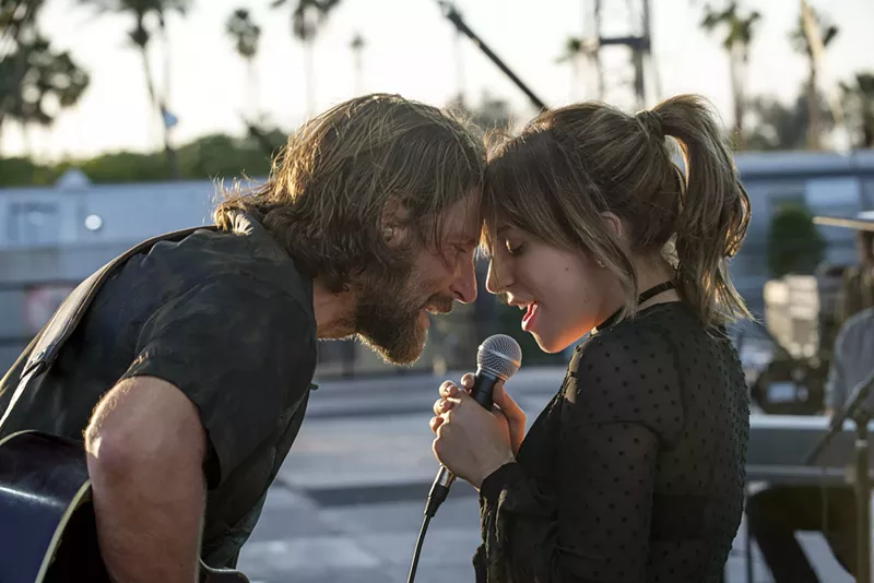 Image: Bradley Cooper (left) makes his directorial debut and co-stars with Lady Gaga in the latest version of A Star Is Born, in which aging rock-and-roller Jackson Maine discovers Ally, a struggling cabaret performer who goes on to gain pop fame.