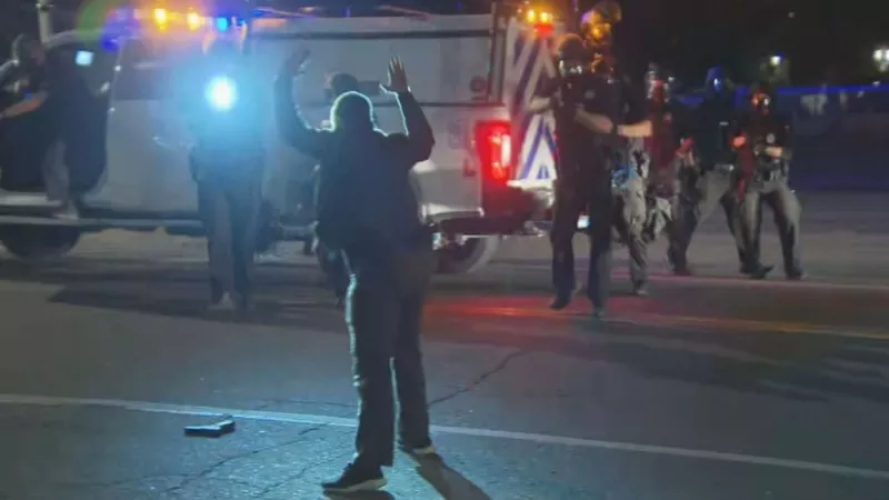 Image: A CBS4 crew was on hand as a man with a gun was taken into custody by Denver police officers during September 23 unrest.