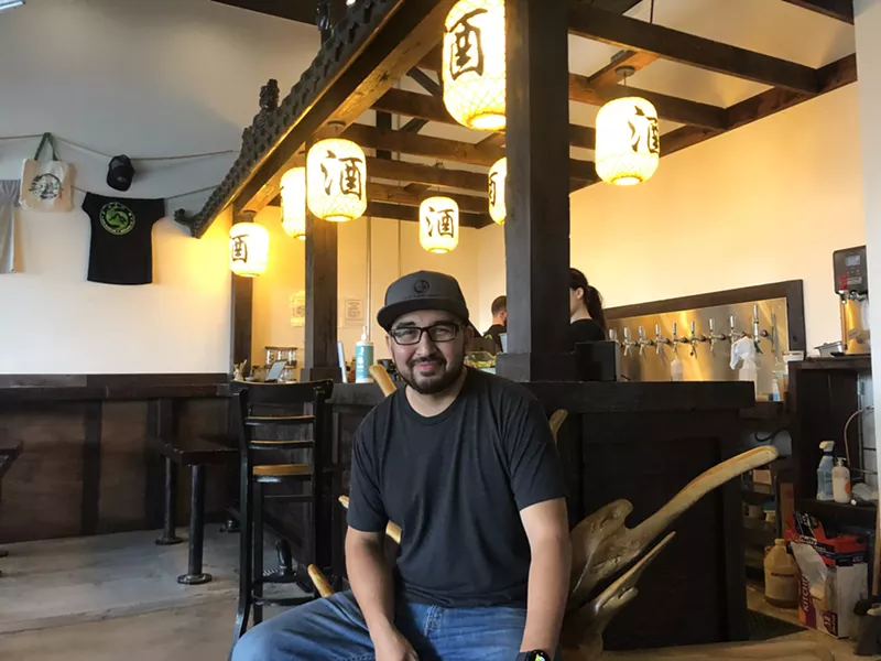 Image: man in black t-shirt inside a brewery