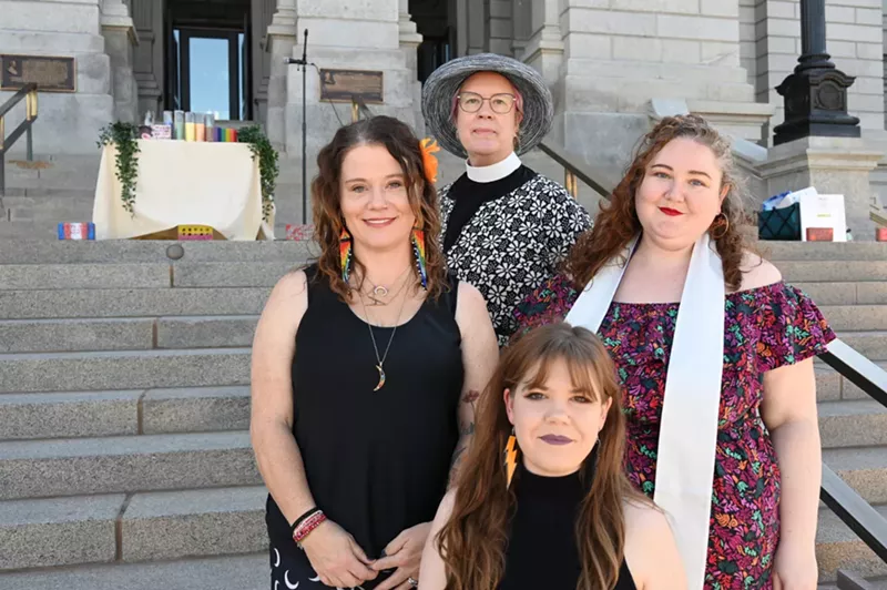 Image: Four women stand in front of the State Capitol west steps.
