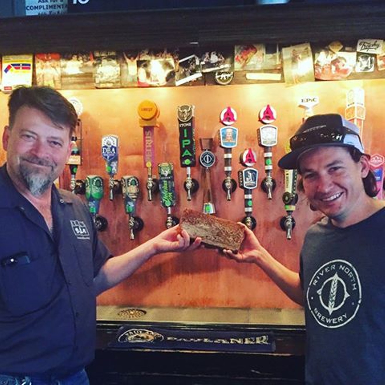 Chris Black (left) of Falling Rock Tap House will mount a brick from River North's original brewery on the wall of his bar.