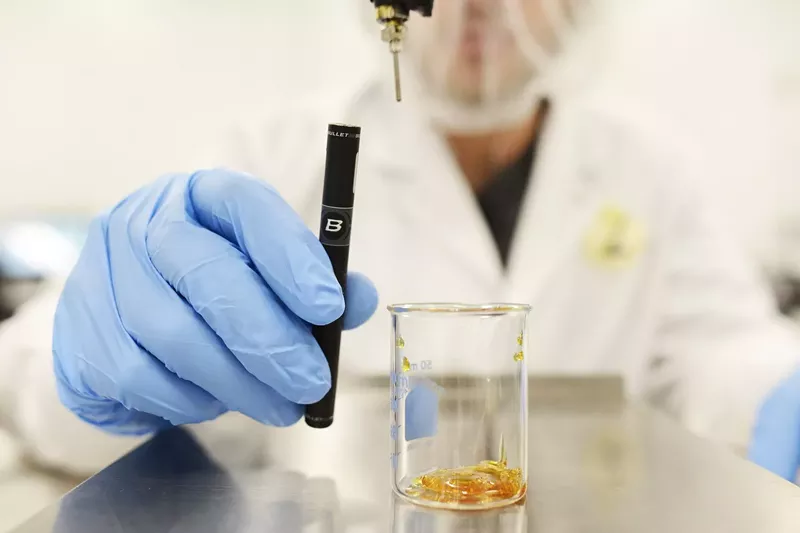 Image: A Bronnor Corporation employee prepares a hash-oil vaporizer.