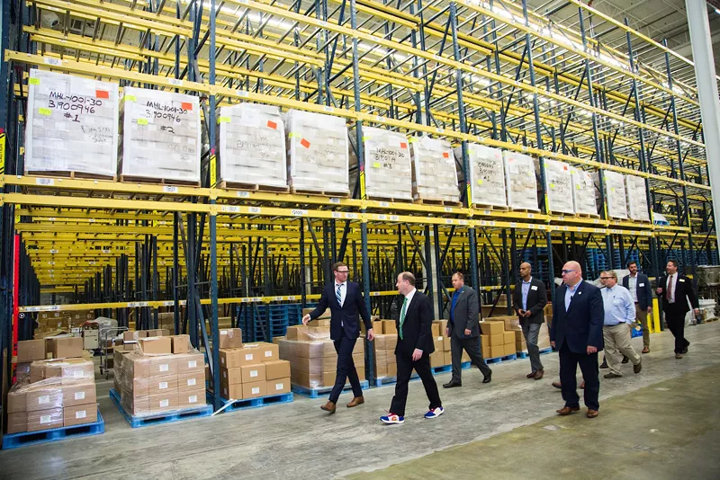 Image: Colorado Governor Jared Polis (front right) and Mile High Labs founder Stephen Mueller (front left) tour the new facility in Broomfield.