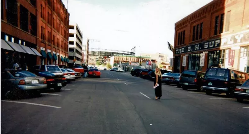 Image: woman walking down a street in denver