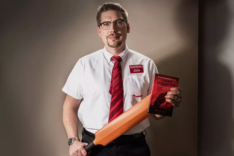 Image: Bryan Hall shows off his love for zombie flicks along with his new book. And a cricket bat, because you never know.