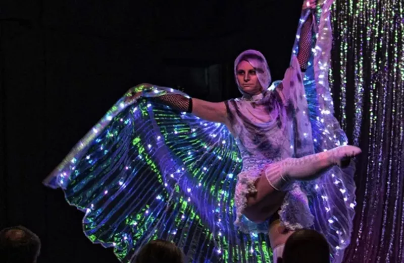 Image: a woman wearing a lightup butterfly outfit