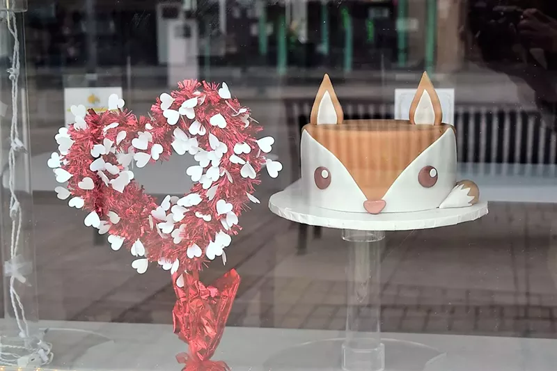 Image: Azucar Bakery displays a fox cake in the window and a reminder that Valentine's Day is around the corner.