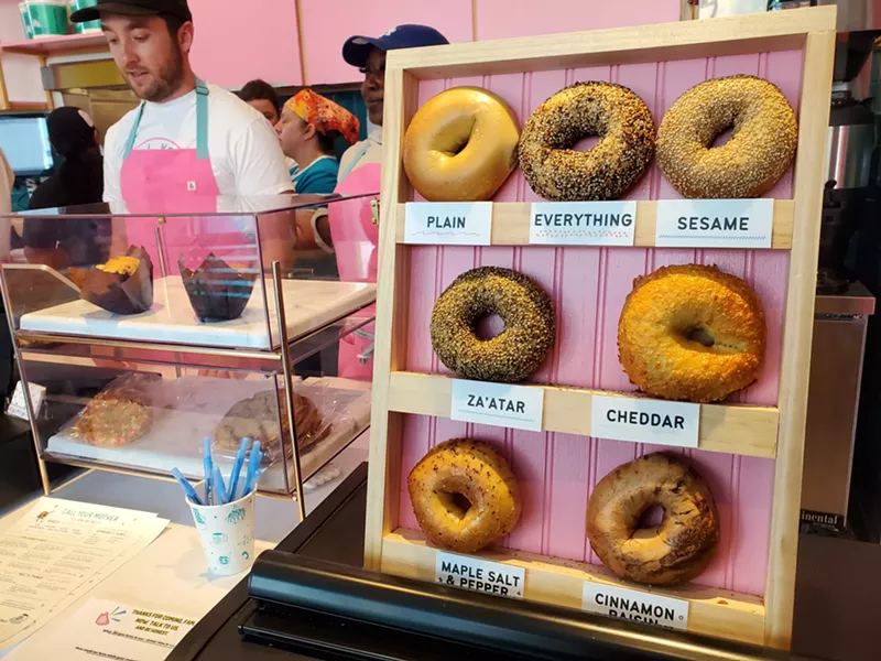 Image: bagels on a vertical display on the counter of a deli