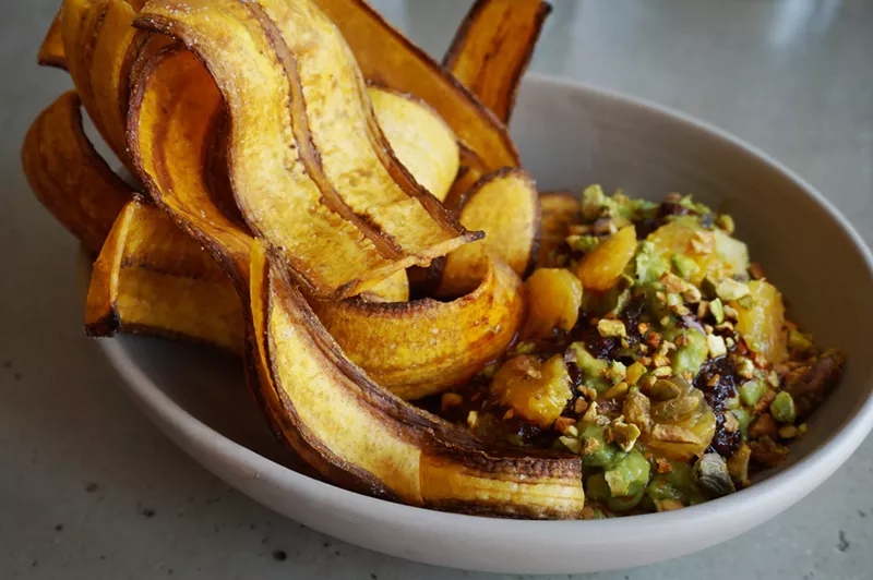 Image: "El Gran Combo" guacamole with guajillo-pistachio mojo, orange and plantain chips.
