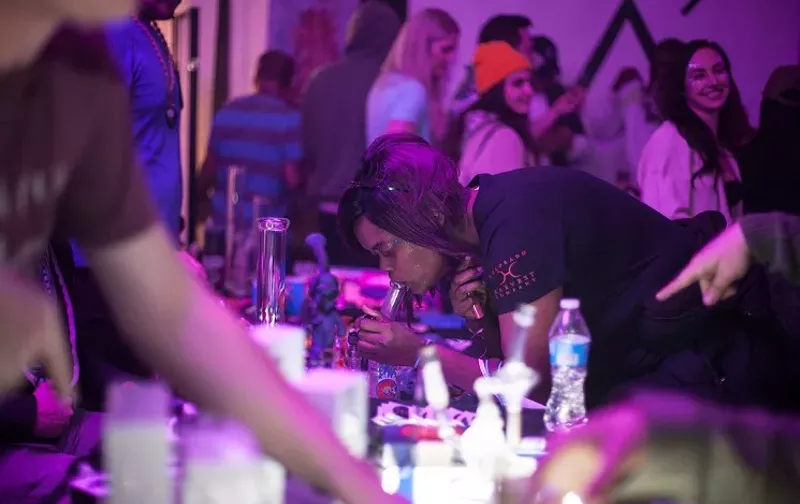 Image: Woman takes hash dab at party