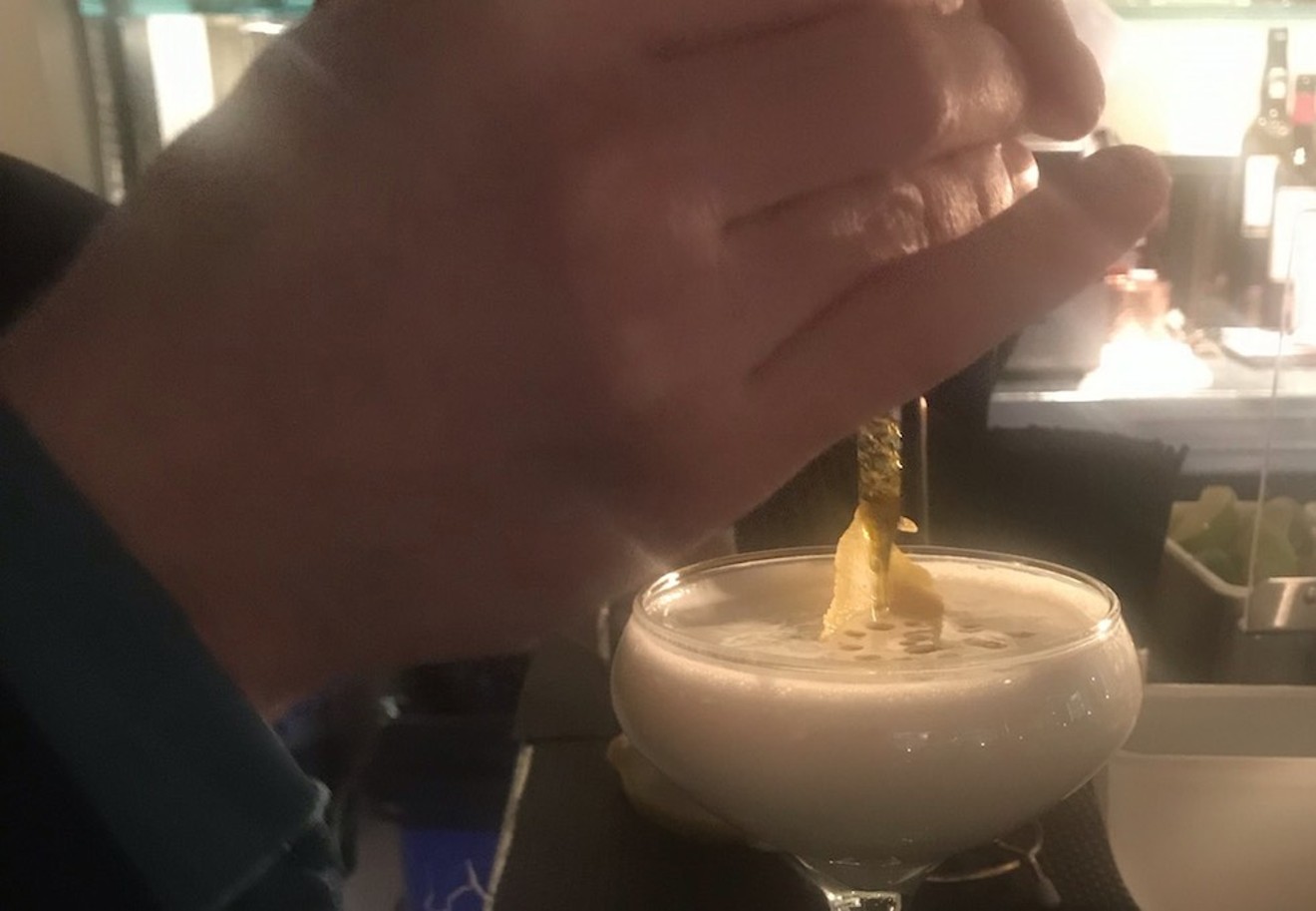 Hotel Teatro's Derrick Odom adds CBD oil to a limoncello cocktail.