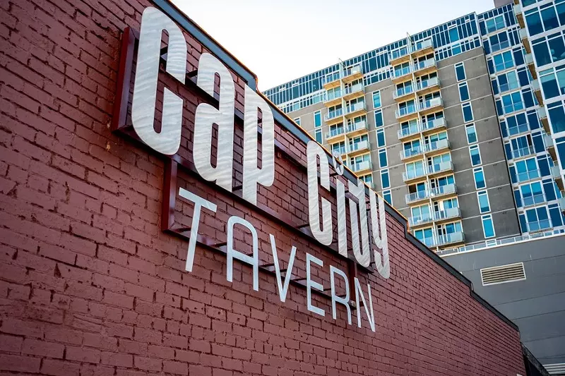 Image: wall of bar with building behind.