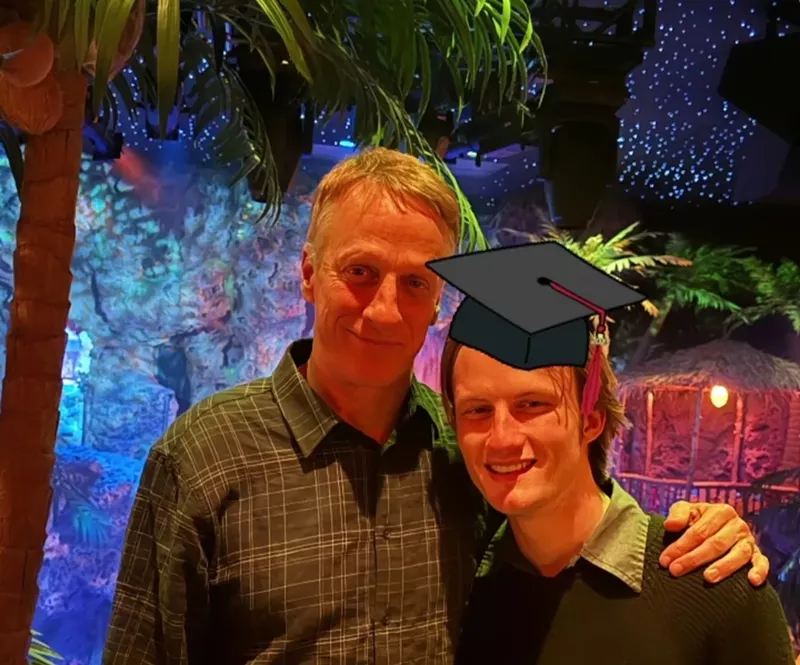 Image: Man and son in graduation hat at Casa Bonita.