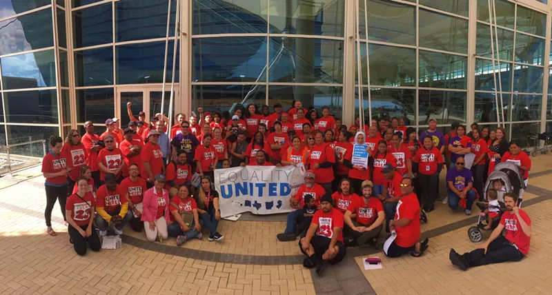 Image: Participants at the demonstration at DIA on Wednesday, May 23, gather for a group photo.