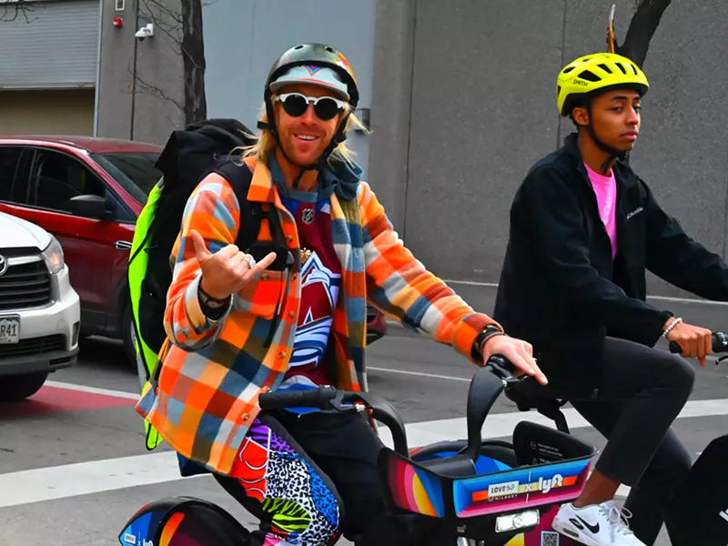 Image: A trippy man rides a bike.