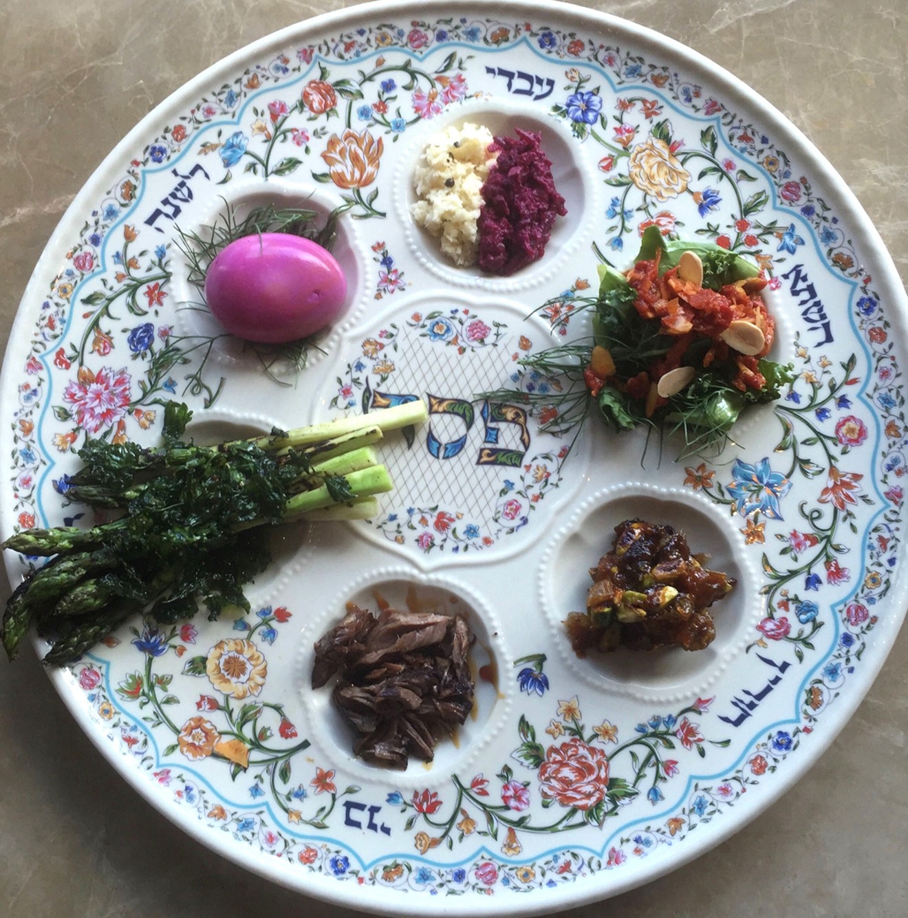 A traditional seder plate holds a shank bone, egg, vegetable, bitter herbs and charoset.