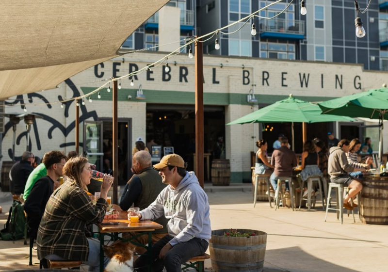 Image: people sitting at tables on a patio