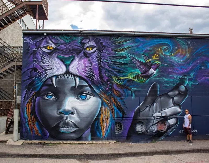 Image: Chad Bolsinger next to one of his murals.