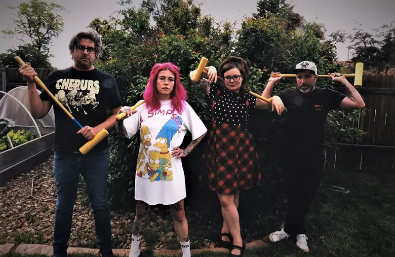 Image: two men and two women standing in a yard