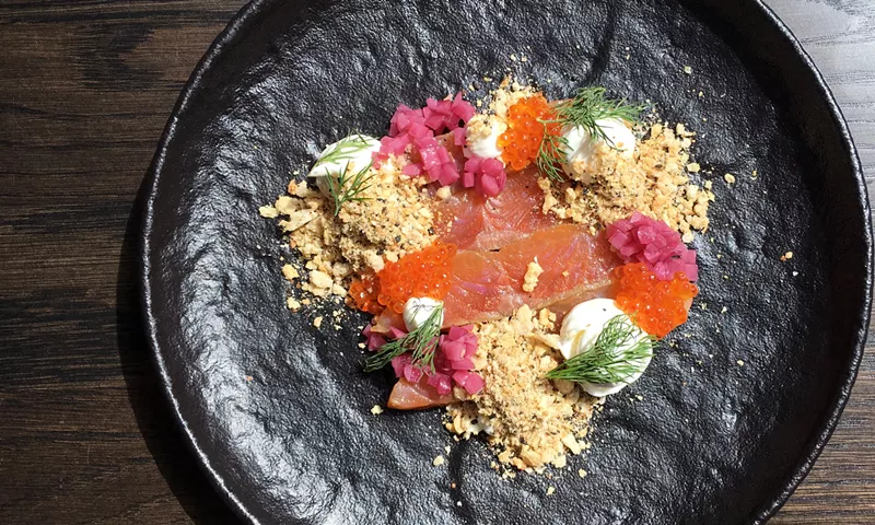 Image: Cured steelhead trout with trout roe, sour cream, pickled onion and "everything" crumble.