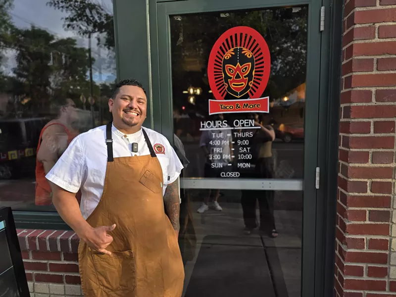 Image: man posing in front of a glass door