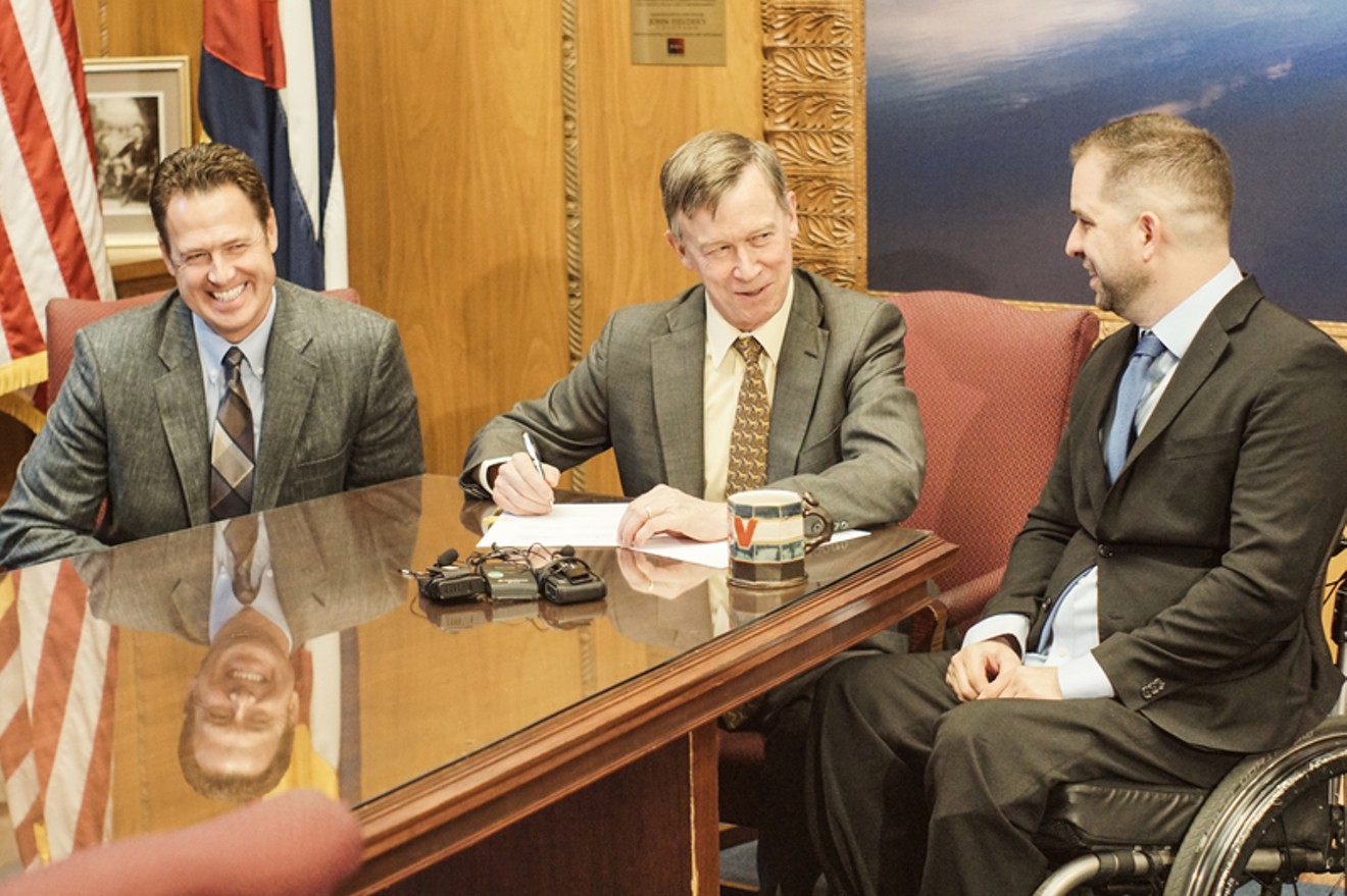 Chris Hinds (right) pictured with Governor Hickenlooper after the Act's signing