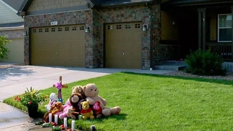 Image: A memorial placed on the lawn of the Watts family home after the news broke.