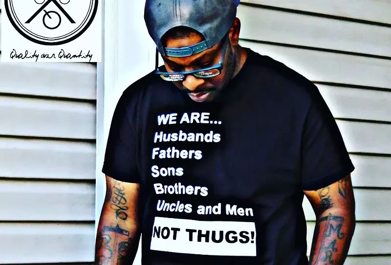 Image: Chy Reco models his new t-shirt design.