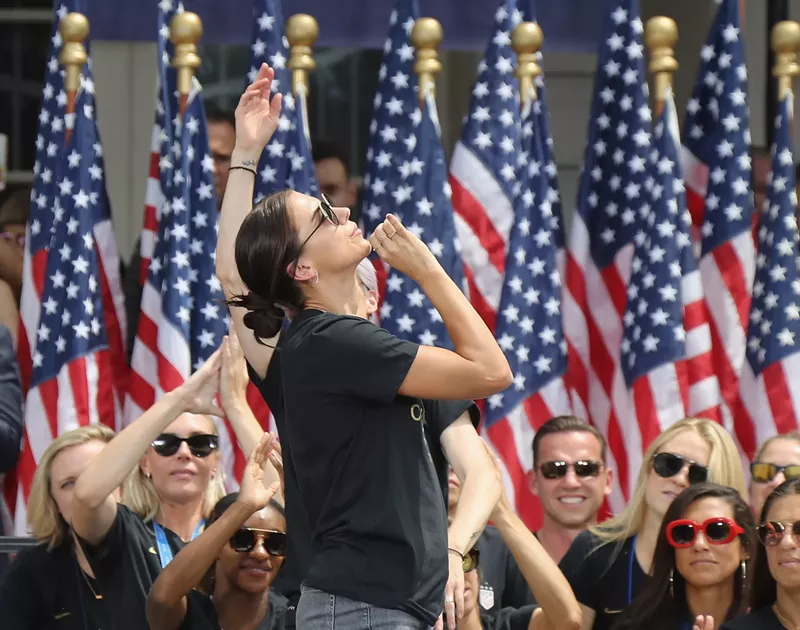 Image: Alex Morgan re-creates the tea sip heard ’round the world during a celebration of the team's victory.