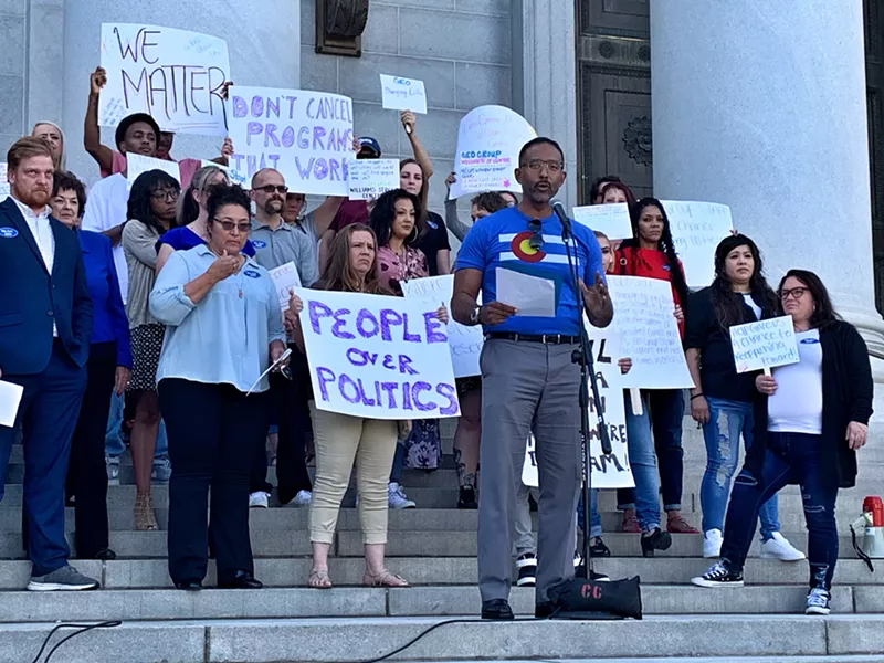 Image: GEO Group halfway house employees and residents gathered outside the Denver City and County Building before a city council vote on halfway house contracts.