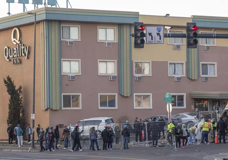 Image: Sweeps of the encampment outside of the Quality Inn, where many migrants had been housed, started early.