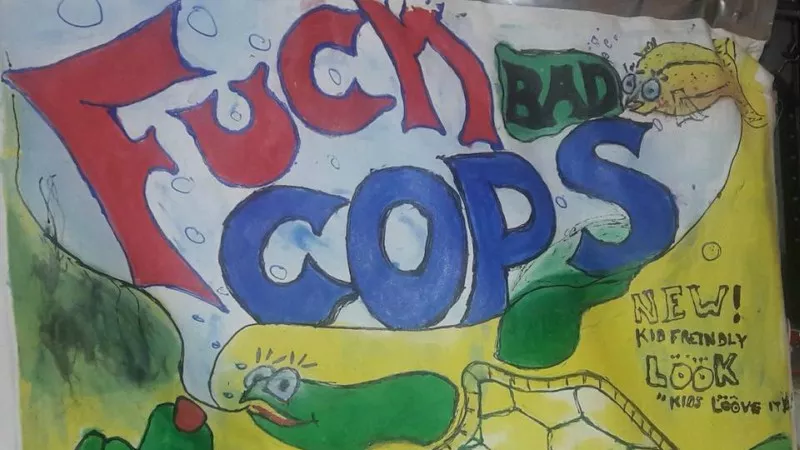 Image: One of Eric Brandt's "Fuck Bad Cops" signs — this one labeled "kids friendly."