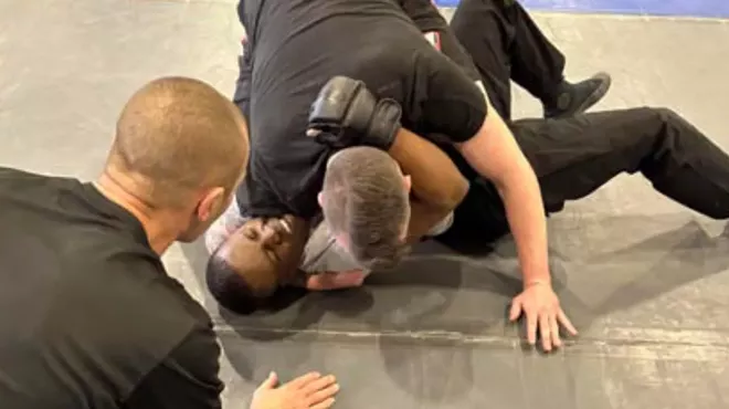 police officer on top of recruit in fight
