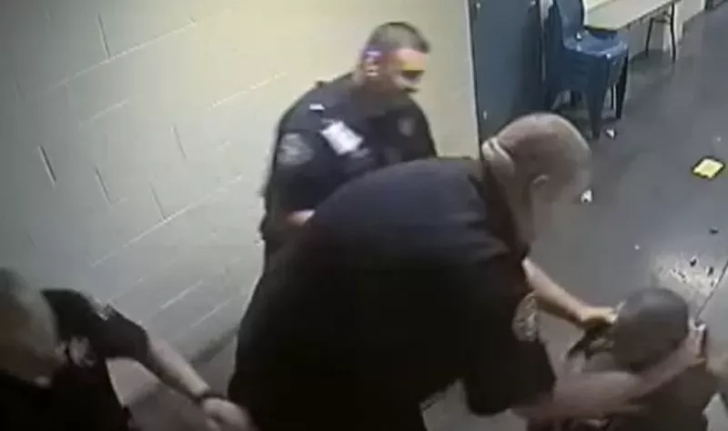 Image: A deputy takes hold of Michael Marshall near the beginning of the incident that led to his death.