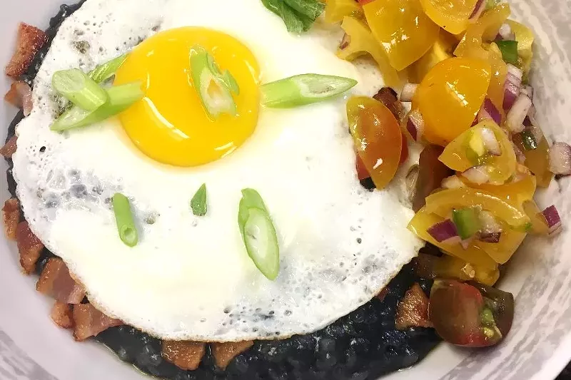 Image: Eggs, bacon, peppers and more top charcoal-infused rice grits in the Coal Bowl.