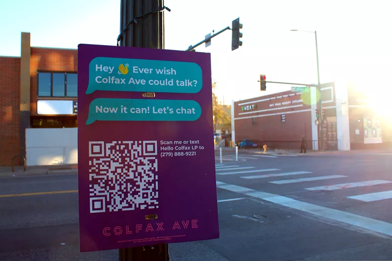 Image: A sign posted on Colfax Avenue with a QR code, asking people to scan it to talk to Colfax.